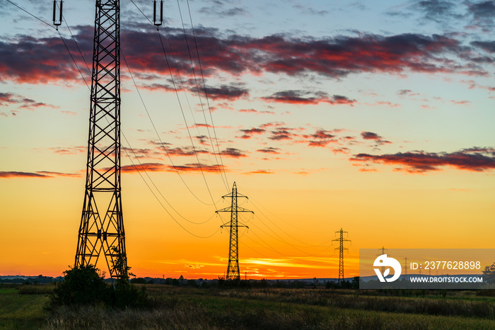 Detail of electric pole with electric cables at sunset