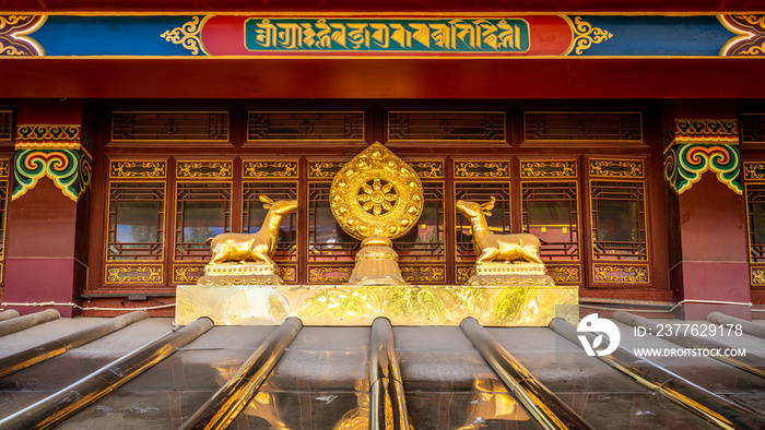 Dharmachakra or Dharma wheel between two deer and colorful details of Dafo Tibetan Buddhist temple Shangri-La Yunnan China