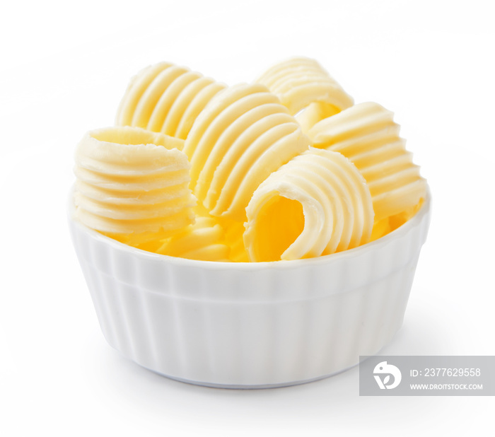 Butter curls or butter rolls in white bowl isolated on white background.