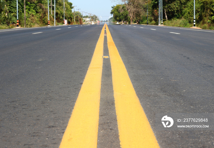 Highway surface with two yellow lines. Asphalt background