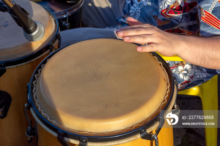 Detail of man playing atabaque during party at the carnival of the city of Belo Horizonte, Minas Gerais