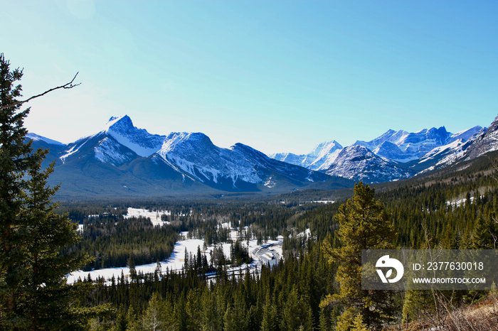 Rocky Mountain frozen river valley on a sunny spring day . Hiking in the mountains, Canada, Alberta