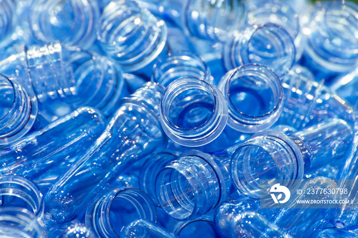 group of blue transparent plastic PET preforms is ready to produce for water drink packaging plastic bottle in the beverage industry. beverage industrial concept. selective focus.