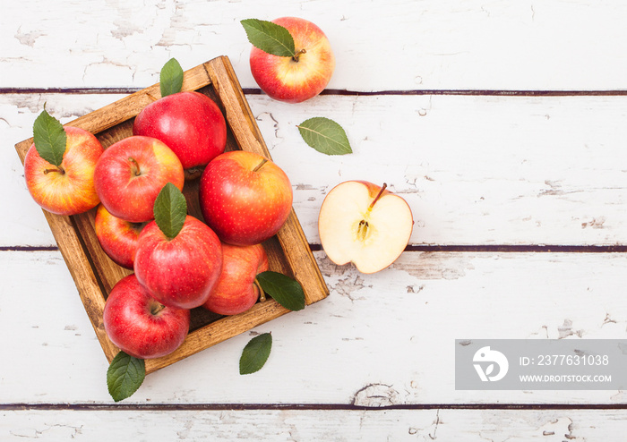 Healthy red organic healthy apples in vintage box on wooden background.