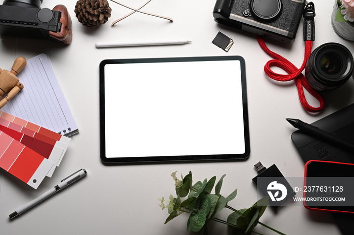 Mock up digital tablet and camera accessories on white table.