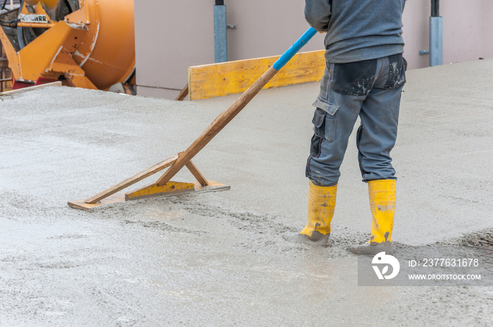 leveling fresh concrete on worksite