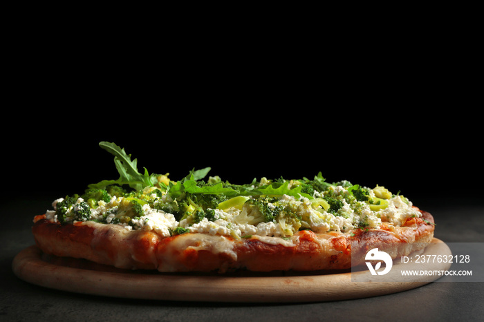 Vegetarian Italian pizza with cheese and vegetables on dark background