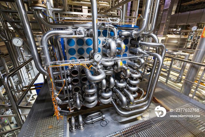 Process heat exchanger at the insulation in process area of pipeline flowing stainless chemical in a factory at control room