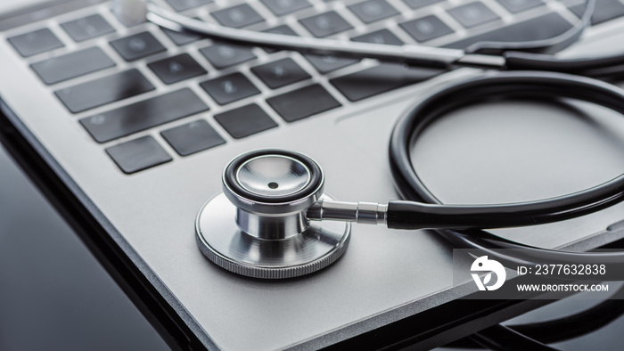 close up view of stethoscope and laptop on glass surface