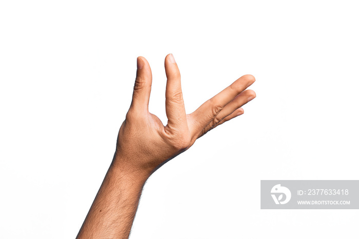 Hand of caucasian young man showing fingers over isolated white background picking and taking invisible thing, holding object with fingers showing space