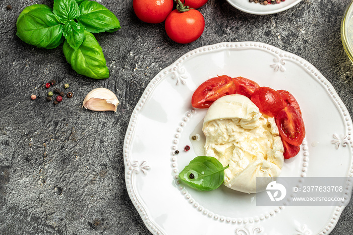 fresh soft white burrata cheese ball made from mozzarella and cream from Apulia, Italian Mediterranean cuisine, Food recipe background. Close up