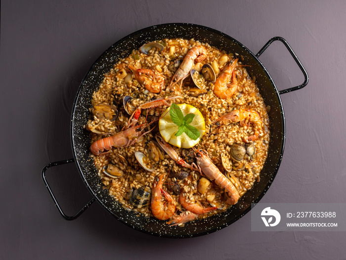 Seafood paella with rustic dark background