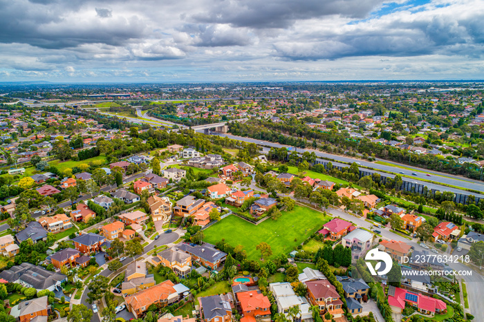 Private residences in Rowville suburb near Eastlink Highway in Melbourne, Australia - aerial view