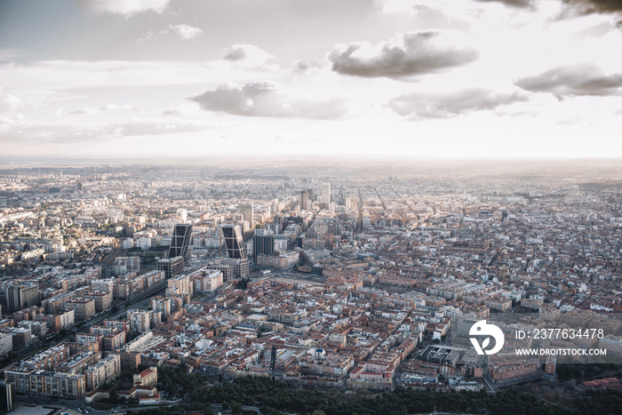 Madrid Skyline at sunset with some emblematic buildings such as Kio Towers, part of the Cuatro Torres Business Area and also a side of Santiago Bernabeu Stadium.