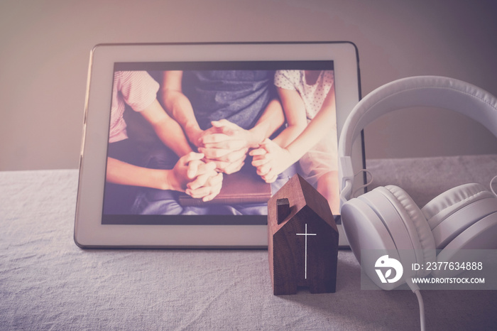 Children praying with father parent with laptop, family and kids worship online together at home, streaming online church service, social distancing concept