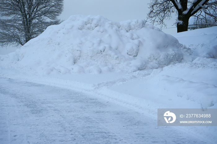 Snow pile, hill by the side of the road.