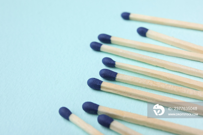 New matchsticks on blue background, closeup