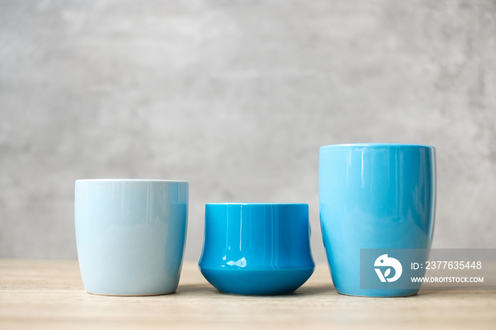 Blue coffee cup and tea mug on wood table background in the morning, Blank copy space for text. International coffee day and daily routine concept