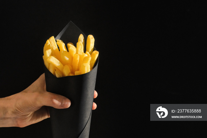 French fries in black paper cone