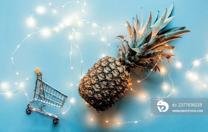 Fresh pineapple with Fairy lights and shopping cart