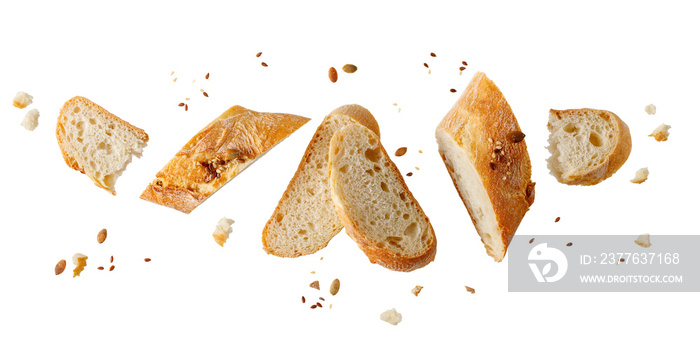 Slices of fresh baked wheat baguette with sunflower, sesame seeds and crumbs flying isolated on white background