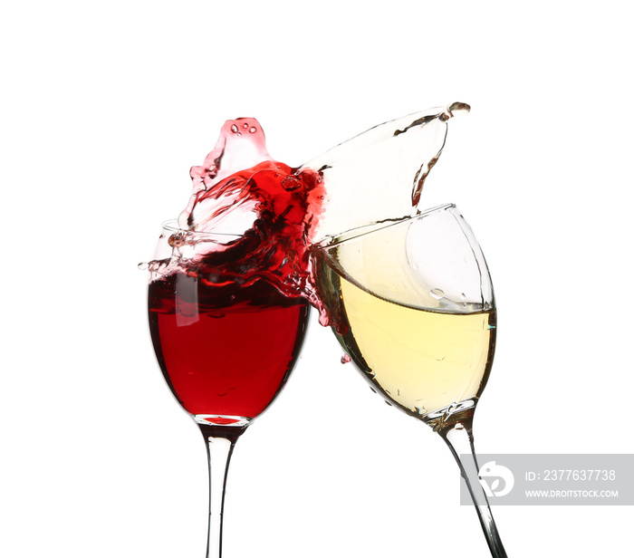 Glasses with splashing wine on white background