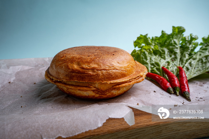 closed burger on wooden board