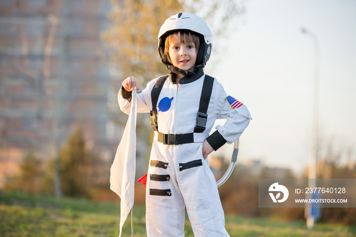 Adorable little boy, dressed as astronaut, playing in park