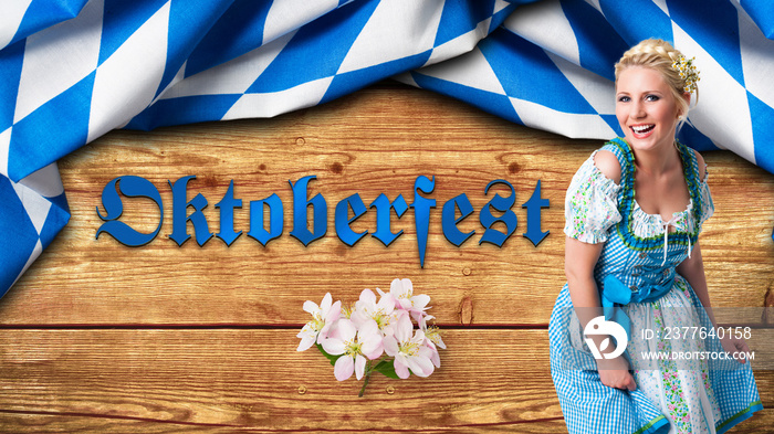 junge Frau im Dirndl vor Hintergrund mit bayrischem Rautenmuster und Aufschrift  Oktoberfest