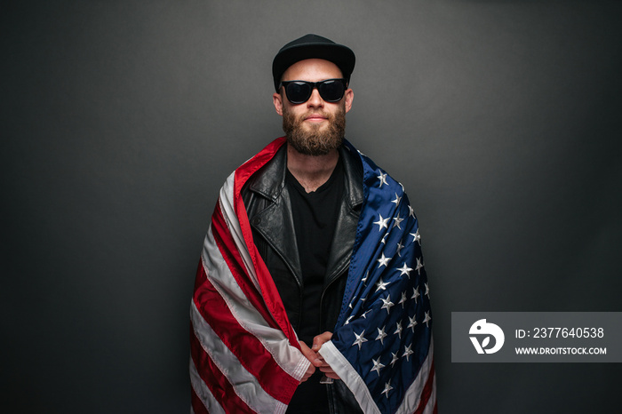 Patriot hipster man holding emotionally american USA flag