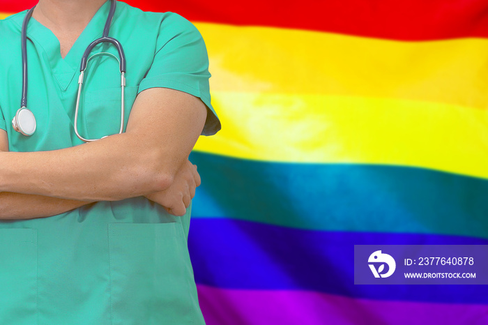 Male surgeon or doctor with stethoscope on the background of the LGBT gay flag. Health care and medical concept. Surgery concept in LGBT gay .