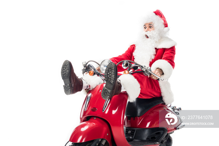 shocked santa claus in costume riding on scooter isolated on white background