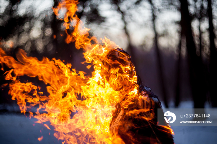 Burning clothing per person. A burning silhouette of a man. Image of a man on fire. Man on Fire. stuntman working on the fire. surrealism theme. Close-up portrait of a burning man.