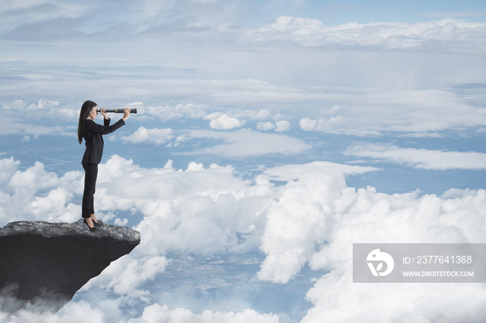 Abstract image of businesswoman with telescope looking into the distance while standing on edge of cliff, mock up place on sky with clouds background. Success, challenge, future and growth concept.