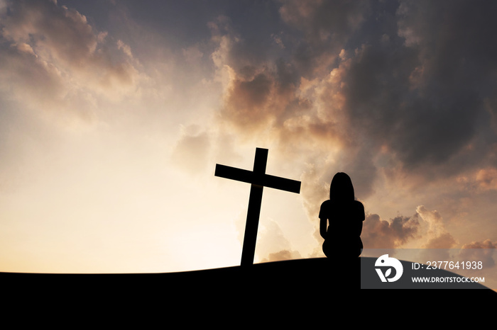 The cross and women on mountain sunset background