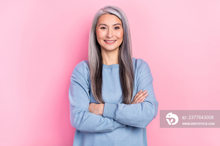 Photo of sweet pretty retired woman blue sweater smiling arms crossed isolated pink color background