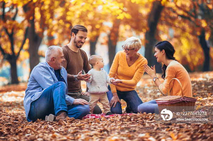 Multl generation family in autumn park having fun