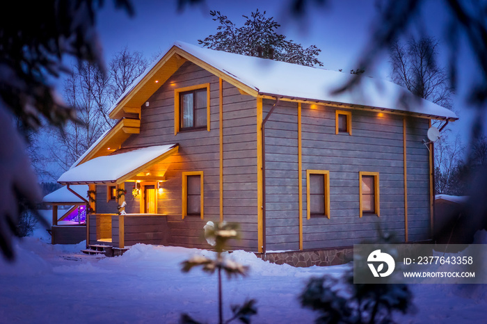 Wooden cottage in winter. Rent cottages for New Year’s holidays.