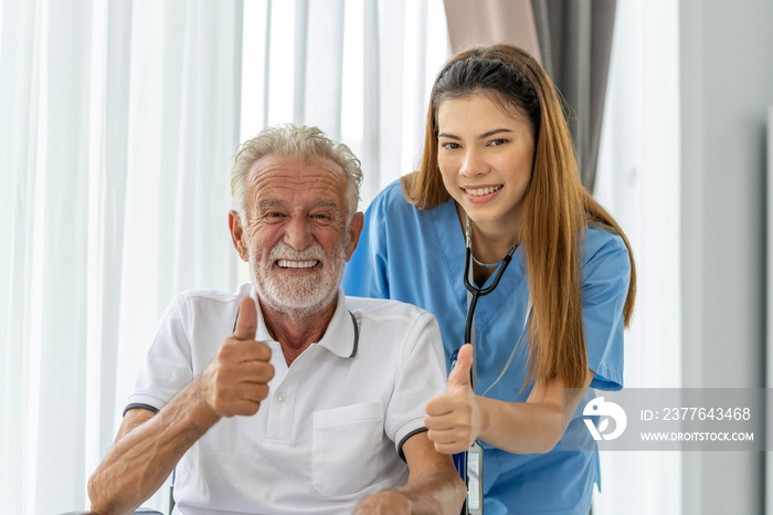 Man being cared for by a private Asian nurse at home suffering from Alzheimer’s disease to closely care for elderly patients with copy space on left