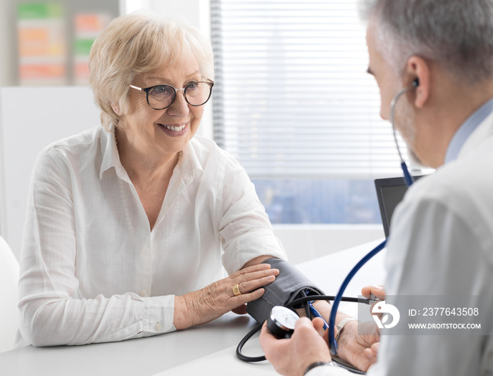 Professional doctor measuring a patient’s blood pressure