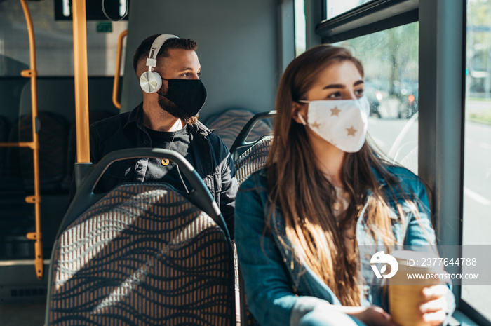 Woman wearing protective mask while riding a bus