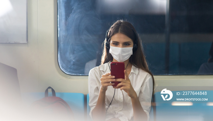 Crowd of passengers on Urban Public Transport Metro. Asian people go to work by public transport. Face Mask protection against virus. Covid-19, coronavirus pandemic