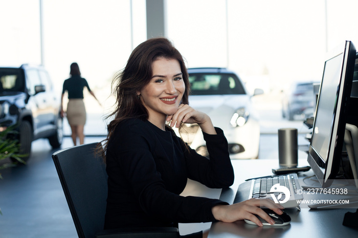 businesswoman giving key at automotive showroom