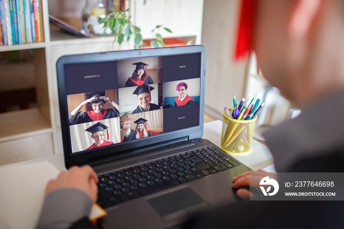 Virtual graduation and convocation ceremony. Laptop screen with happy students wearing graduation gown and cap receiving congratulation from professor during online video call, distant education