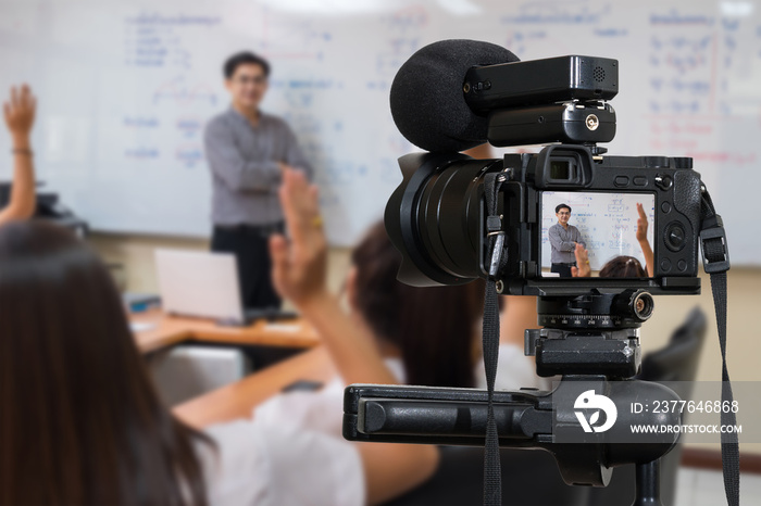 Professional digital Mirrorless camera with microphone on the tripod recording video blog of Asian teacher in the classroom,Camera for photographer or Video and Technology Live Streaming concept