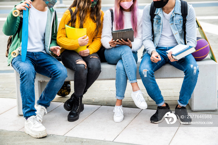 Group of students wearing face mask studying together - New normal lifestyle concept with young people at school