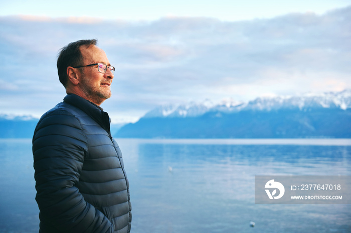 Handsome middle age man relaxing by winter lake