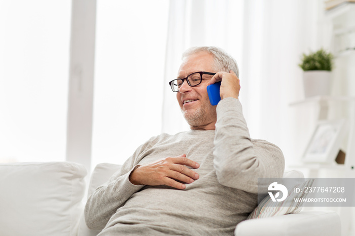 happy senior man calling on smartphone at home