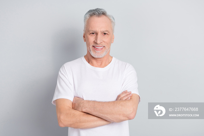 Photo of good older man crossed arms wear white t-shirt isolated on grey color background