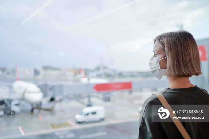 Woman wearing a face mask for prevent virus in international airport. Protection against Coronavirus.